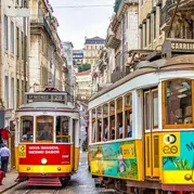 Two colourful trams in a city